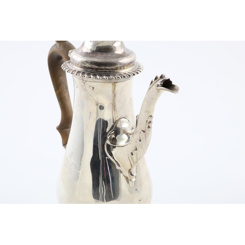 136 - A GEORGE III COFFEE POT. of baluster form, with a domed cover, domed foot, gadrooned borders and a l... 