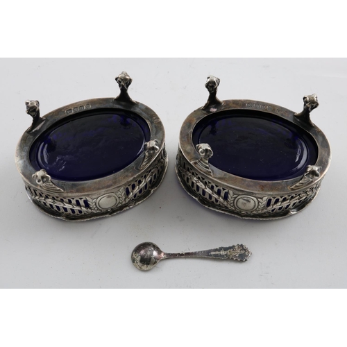 145 - A PAIR OF GEORGE III PIERCED OVAL SALTS. on ball and claw feet, with wavy gadrooned rims, blue glass... 