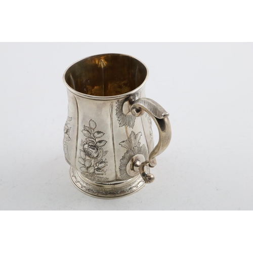 152 - A GEORGE II MUG. of lobed baluster form, with a scroll handle, later foliate decoration and a  circu... 