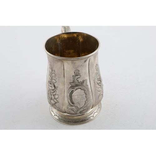 152 - A GEORGE II MUG. of lobed baluster form, with a scroll handle, later foliate decoration and a  circu... 