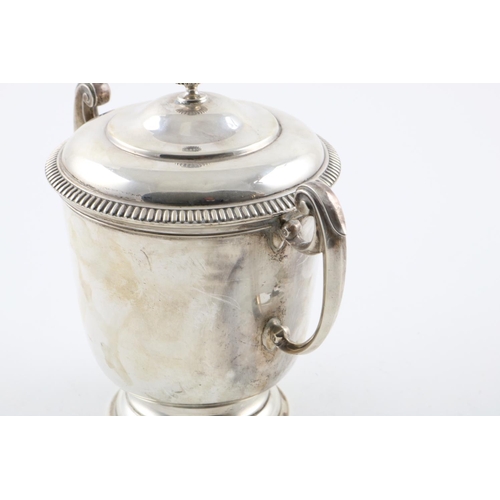 157 - A GEORGE V TWO-HANDLED CUP AND COVER. the domed cover with a fluted finial, the body with  scroll ha... 