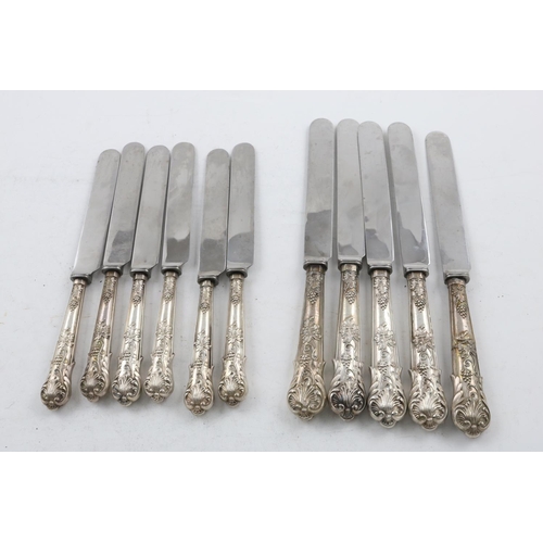 49 - A SET OF FIVE VICTORIAN TABLE KNIVES AND SIX MATCHING SIDE KNIVES. of a decorative pattern, with fru... 