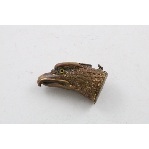 87 - A LATE 19TH/EARLY 20TH CENTURY GILT BRASS EAGLE HEAD VESTA CASE. with two glass eyes and a suspensor... 