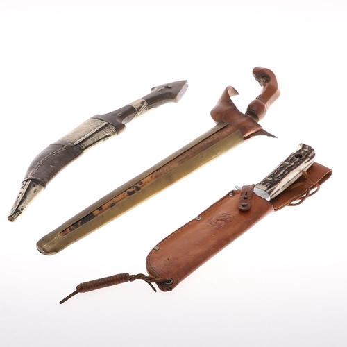 108 - AN INDONESIAN KRIS KNIFE AND SCABBARD AND TWO OTHERS. A Kris with a 31cm blade with typically wavy e... 