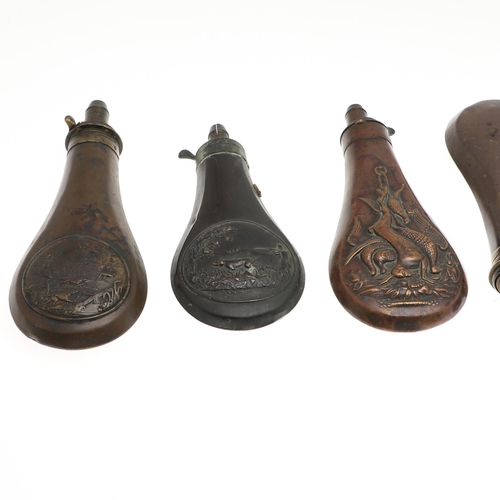 26 - A COLLECTION OF SEVEN COPPER BODIED POWDER FLASKS. A collection of seven flasks with various decorat... 