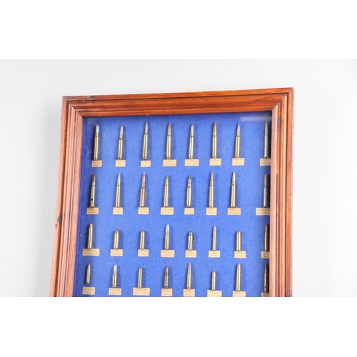 27 - A DISPLAY CASE CONTAINING A COLLECTION OF BULLETS OF VARIOUS TYPES. A collection of eighty different... 