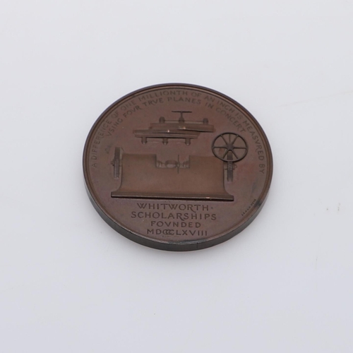 453 - A WHITWORTH SCHOLARSHIP BRONZE MEDAL, 1868. A bronze award medal, The obverse with a bust by A. Wyon... 