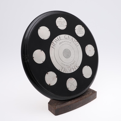 489 - A HOME GUARD SILVER MOUNTED SHOOTING TROPHY. An ebonised circular wooden trophy mounted with a centr... 