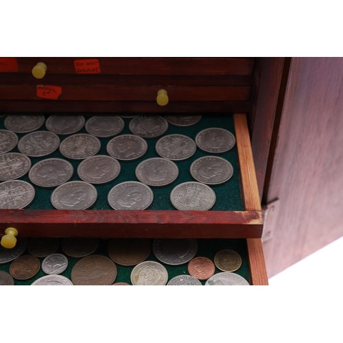 683 - AN EALY 20TH CENTURY STAINED PINE COIN COLLECTORS CABINET. A two door cabinet containing fifteen tra... 