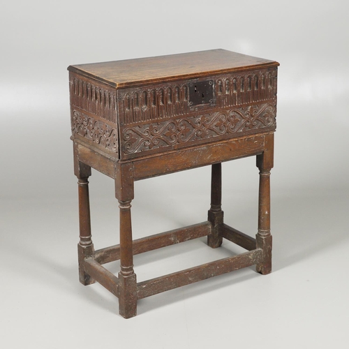 688 - A COIN CABINET MADE FROM A SEVENTEENTH CENTURY OAK BOX ON STAND. A coin or medal cabinet formed from... 