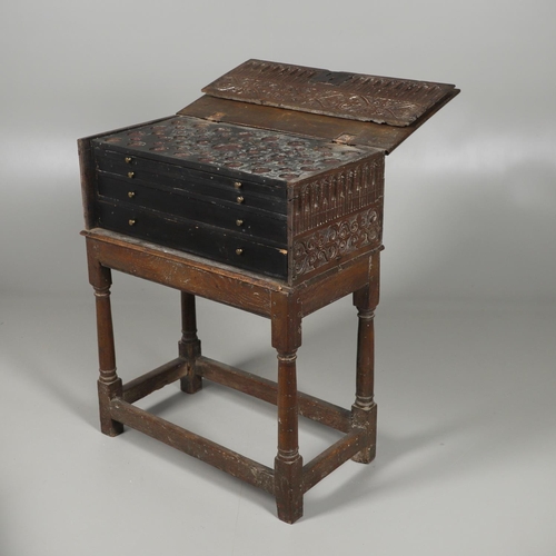 688 - A COIN CABINET MADE FROM A SEVENTEENTH CENTURY OAK BOX ON STAND. A coin or medal cabinet formed from... 