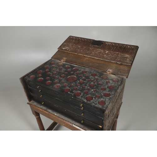 688 - A COIN CABINET MADE FROM A SEVENTEENTH CENTURY OAK BOX ON STAND. A coin or medal cabinet formed from... 