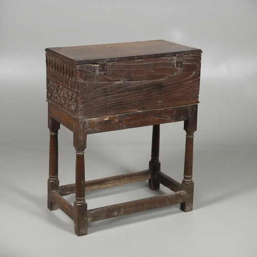 688 - A COIN CABINET MADE FROM A SEVENTEENTH CENTURY OAK BOX ON STAND. A coin or medal cabinet formed from... 