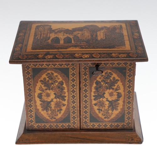 642 - VICTORIAN TUNBRIDGE WARE TABLE CABINET. A walnut and inlaid table cabinet, the lid with a depiction ... 