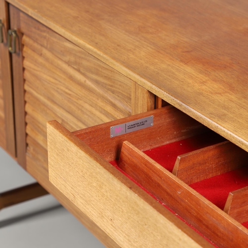 670 - MCINTOSH - TEAK MID CENTURY DINING SUITE. Comprising a sideboard with three drawers and large two do... 