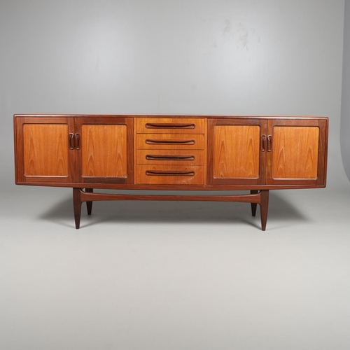 671 - G-PLAN - A LARGE TEAK MID CENTURY SIDEBOARD. A large G-Plan sideboard with four central drawers flan... 