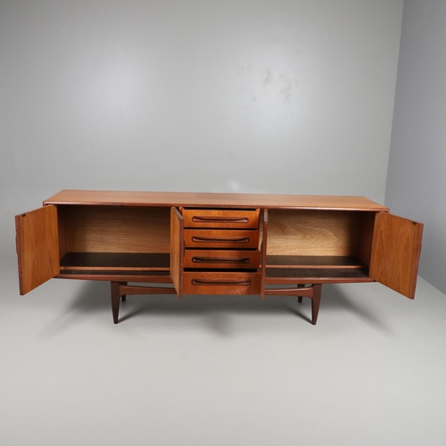 671 - G-PLAN - A LARGE TEAK MID CENTURY SIDEBOARD. A large G-Plan sideboard with four central drawers flan... 