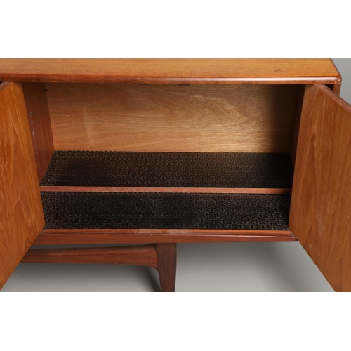 671 - G-PLAN - A LARGE TEAK MID CENTURY SIDEBOARD. A large G-Plan sideboard with four central drawers flan... 