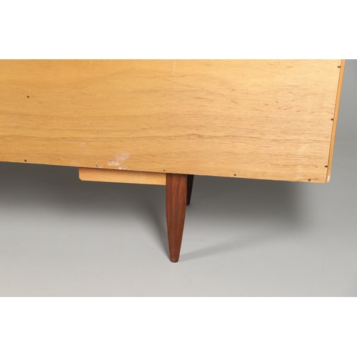 671 - G-PLAN - A LARGE TEAK MID CENTURY SIDEBOARD. A large G-Plan sideboard with four central drawers flan... 