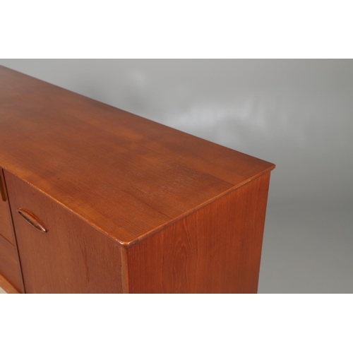 672 - A MID CENTURY TEAK SIDEBOARD. The sideboard with three central drawers flanked by cupboards, and sup... 