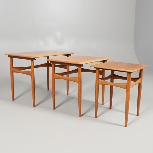 673 - H C ANDERSON - A DANISH MID CENTURY TEAK NEST OF TABLES. A nest of three teak tables, of rectangular... 