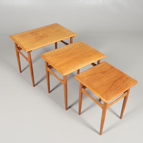 673 - H C ANDERSON - A DANISH MID CENTURY TEAK NEST OF TABLES. A nest of three teak tables, of rectangular... 