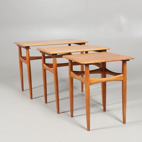 673 - H C ANDERSON - A DANISH MID CENTURY TEAK NEST OF TABLES. A nest of three teak tables, of rectangular... 