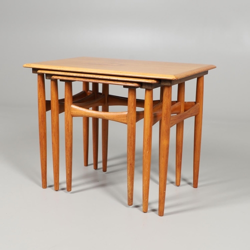 673 - H C ANDERSON - A DANISH MID CENTURY TEAK NEST OF TABLES. A nest of three teak tables, of rectangular... 