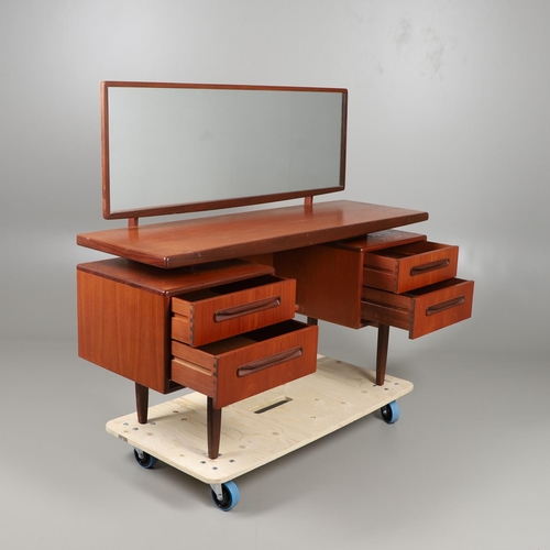 674 - A MID CENTURY G-PLAN TEAK DRESSING TABLE AND MATCHING CHEST OF DRAWERS. The dressing table with two ... 