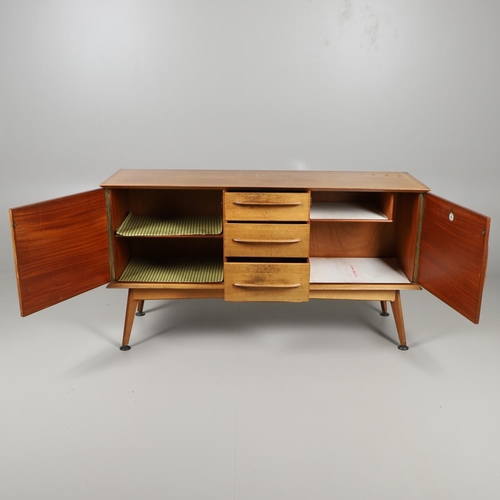 675 - A MID CENTURY TEAK SIDEBOARD & DINING TABLE - HANDCRAFT. With three central drawers flanked by two c... 