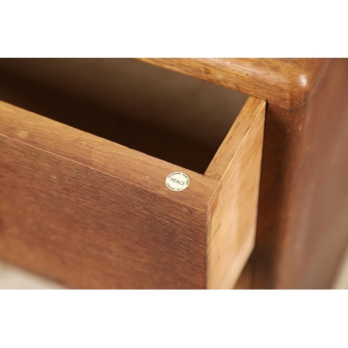 677 - A HEALS LIMED OAK DRESSING CHEST. The dressing chest with two drawers and curved handles, with a sma... 