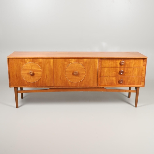 684 - MID CENTURY TEAK SIDEBOARD. A large sideboard with two cupboard doors with circular panels and inter... 