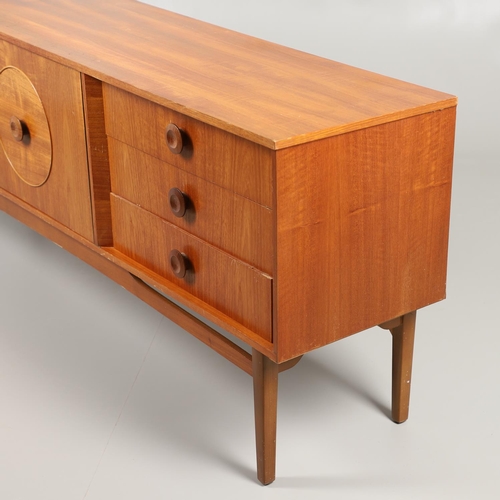 684 - MID CENTURY TEAK SIDEBOARD. A large sideboard with two cupboard doors with circular panels and inter... 