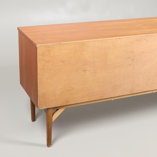 684 - MID CENTURY TEAK SIDEBOARD. A large sideboard with two cupboard doors with circular panels and inter... 