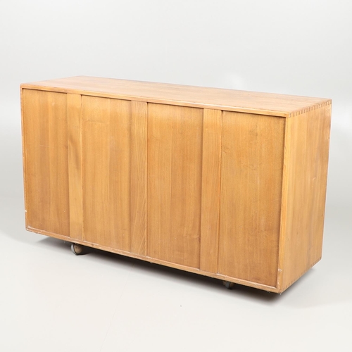 685 - VINTAGE ERCOL SIDEBOARD. A light elm sideboard with two large cupboard doors and internal shelf, wit... 