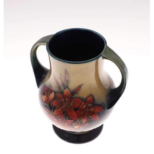 690 - MOORCROFT TWO HANDLED VASE - SPRING FLOWERS. A two handled vase, painted in the 'Spring Flowers' des... 