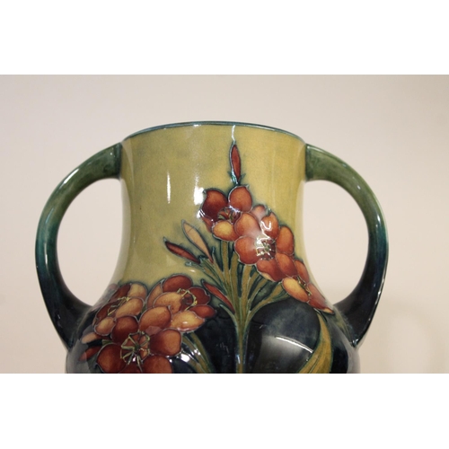 690 - MOORCROFT TWO HANDLED VASE - SPRING FLOWERS. A two handled vase, painted in the 'Spring Flowers' des... 