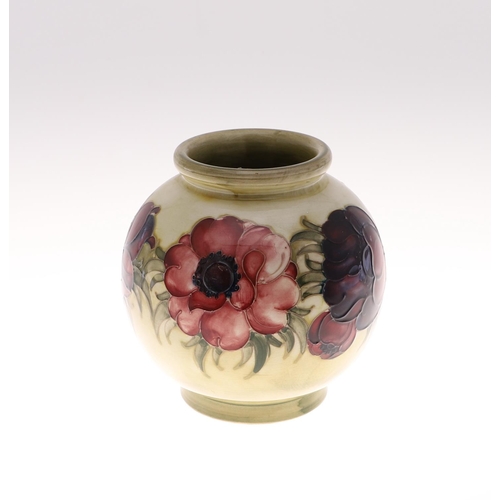 695 - ANTIQUE MOORCROFT ANEMONE VASE. A globular vase painted in the Anemone design on an unusual pale gre... 