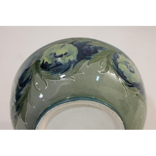 696 - ANTIQUE MOORCROFT BOWL - LATE FLORIAN. A large bowl painted with flowers and leaves on a blue and gr... 