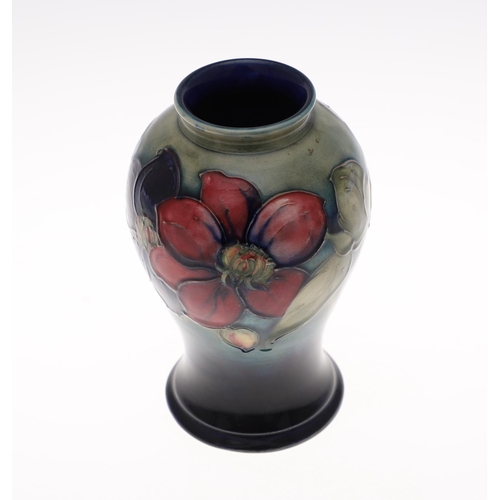 698 - ANTIQUE MOORCROFT VASE - CLEMATIS. The vase painted in the Clematis design on a green and blue groun... 