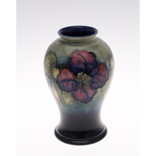 698 - ANTIQUE MOORCROFT VASE - CLEMATIS. The vase painted in the Clematis design on a green and blue groun... 