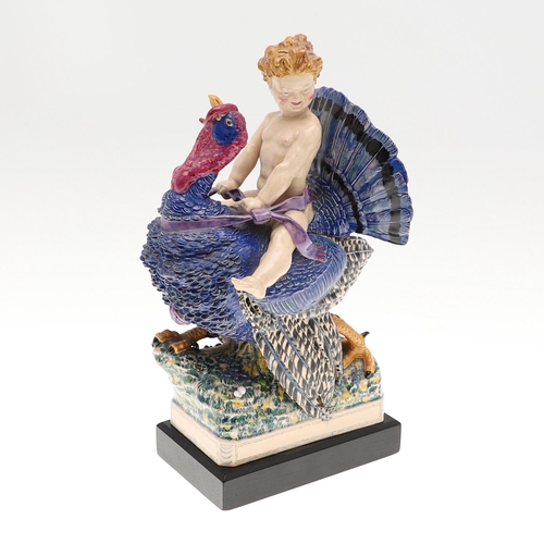 701 - HARRY PARR - CHELSEA POTTERY FIGURE, 1934. A pottery figure of a boy riding a Turkey, brightly paint... 