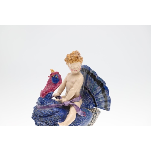 701 - HARRY PARR - CHELSEA POTTERY FIGURE, 1934. A pottery figure of a boy riding a Turkey, brightly paint... 