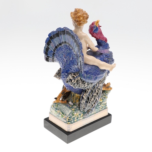 701 - HARRY PARR - CHELSEA POTTERY FIGURE, 1934. A pottery figure of a boy riding a Turkey, brightly paint... 