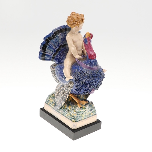 701 - HARRY PARR - CHELSEA POTTERY FIGURE, 1934. A pottery figure of a boy riding a Turkey, brightly paint... 