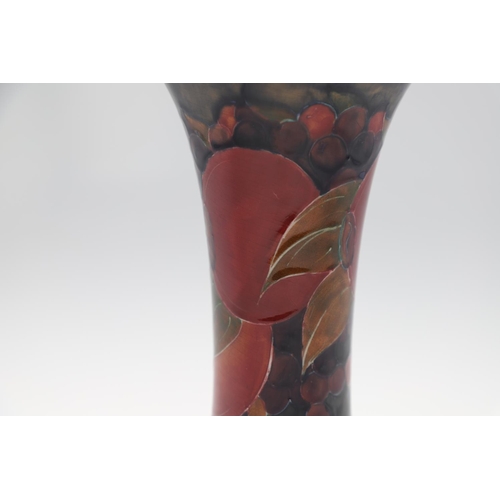 720 - ANTIQUE MOORCROFT POMEGRANATE VASE. The vase of trumpet form, painted in the Pomegranate design on a... 