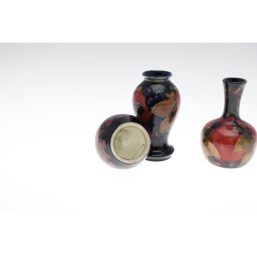 722 - MOORCROFT MINIATURE VASES - POMEGRANATE. Including a miniature baluster shaped vase painted in the P... 