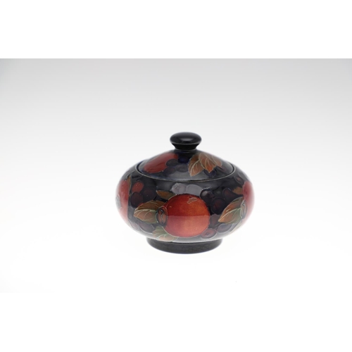 726 - MOORCROFT LIDDED JAR, & THREE OTHER LIDDED JARS. An ovoid lidded jar in the Pomegranate design, 15cm... 