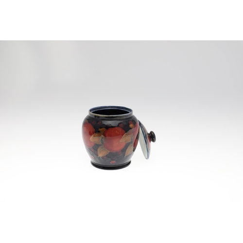 726 - MOORCROFT LIDDED JAR, & THREE OTHER LIDDED JARS. An ovoid lidded jar in the Pomegranate design, 15cm... 