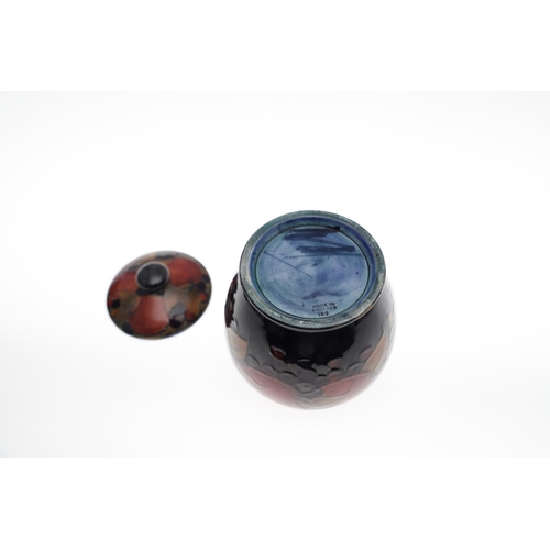 726 - MOORCROFT LIDDED JAR, & THREE OTHER LIDDED JARS. An ovoid lidded jar in the Pomegranate design, 15cm... 